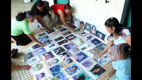 Volunteers in Honduras show photos of some of the missing migrants they are searching for. In the city of El Progreso, at least 350 people have gone missing on the dangerous trek north from the Central American nation to the United States.