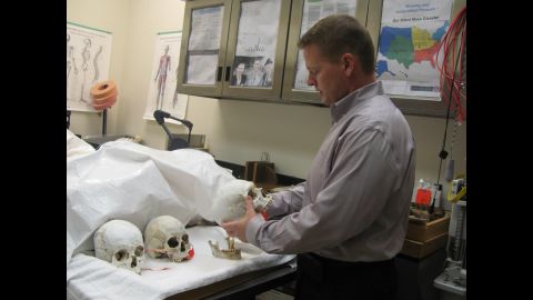 Gregory Hess, the coroner in Pima County, Arizona, inspects some human remains kept at the morgue. Since 2001, more than 2,000 migrants have been found dead in the Arizona desert, many of them without any identification.