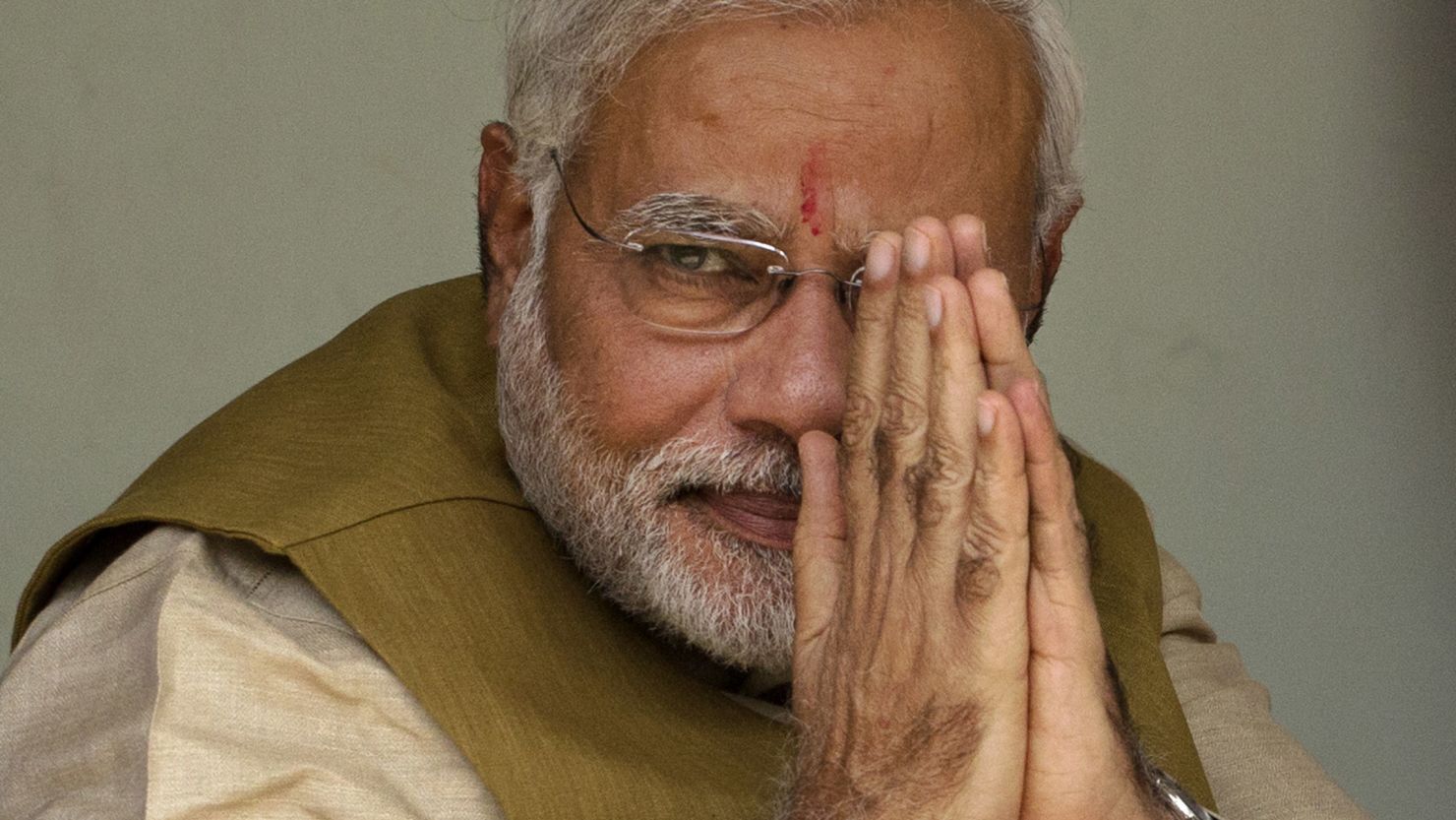 Narendra Modi gestures to supporters after seeking his mother's blessing in Ahmedabad, India on May 16, 2014.
