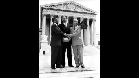 From left, lawyers George E.C. Hayes, Thurgood Marshall and James M. Nabrit join hands outside the US Supreme Court on May 17, 1954, in celebration of the court's historic ruling. The ruling read in part: "We conclude that, in the field of public education, the doctrine of 'separate but equal' has no place. Separate educational facilities are inherently unequal."