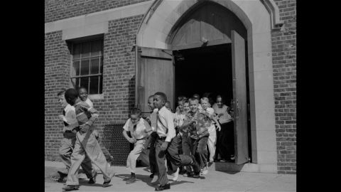 Fourth-graders, both black and white, dash for the playground at St. Martin School in Washington on September 17, 1954. The Supreme Court ruling did not set a schedule for the integration of schools, rather calling for "deliberate speed." The District of Columbia and four states acted to end segregation promptly, while other areas met with resistance.