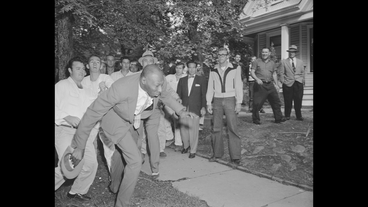 Alex Wilson, a reporter from the Tri-State Defender, is shoved by an angry mob of white people near Central High School in Little Rock, Arkansas, on September 23, 1957. The fight started when nine black students gained entrance to the school as the US Army enforced integration. 