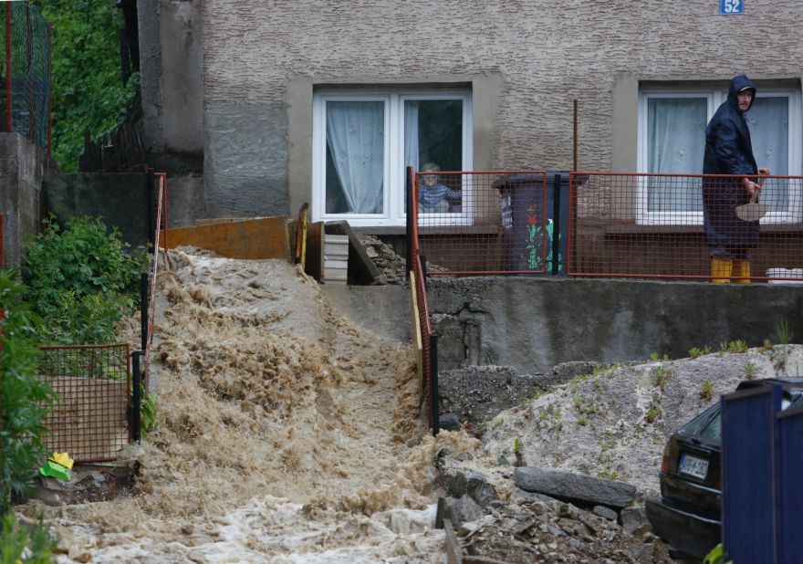 A man works to divert a stream of water from his home near Zenica, Bosnia-Herzegovina, on May 15.