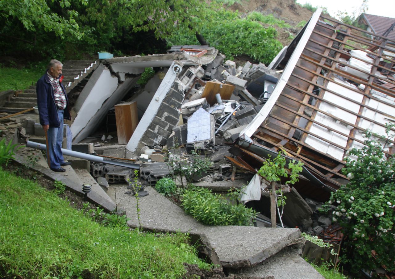 A man surveys the damage after a landslide near Sarajevo on May 15.
