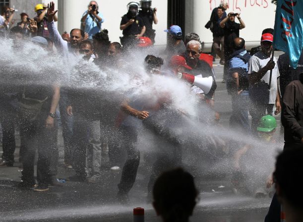 Police use water cannons and tear gas to disperse people gathered to commemorate victims and protest the government's labor policy in Izmir, Turkey, on May 16.