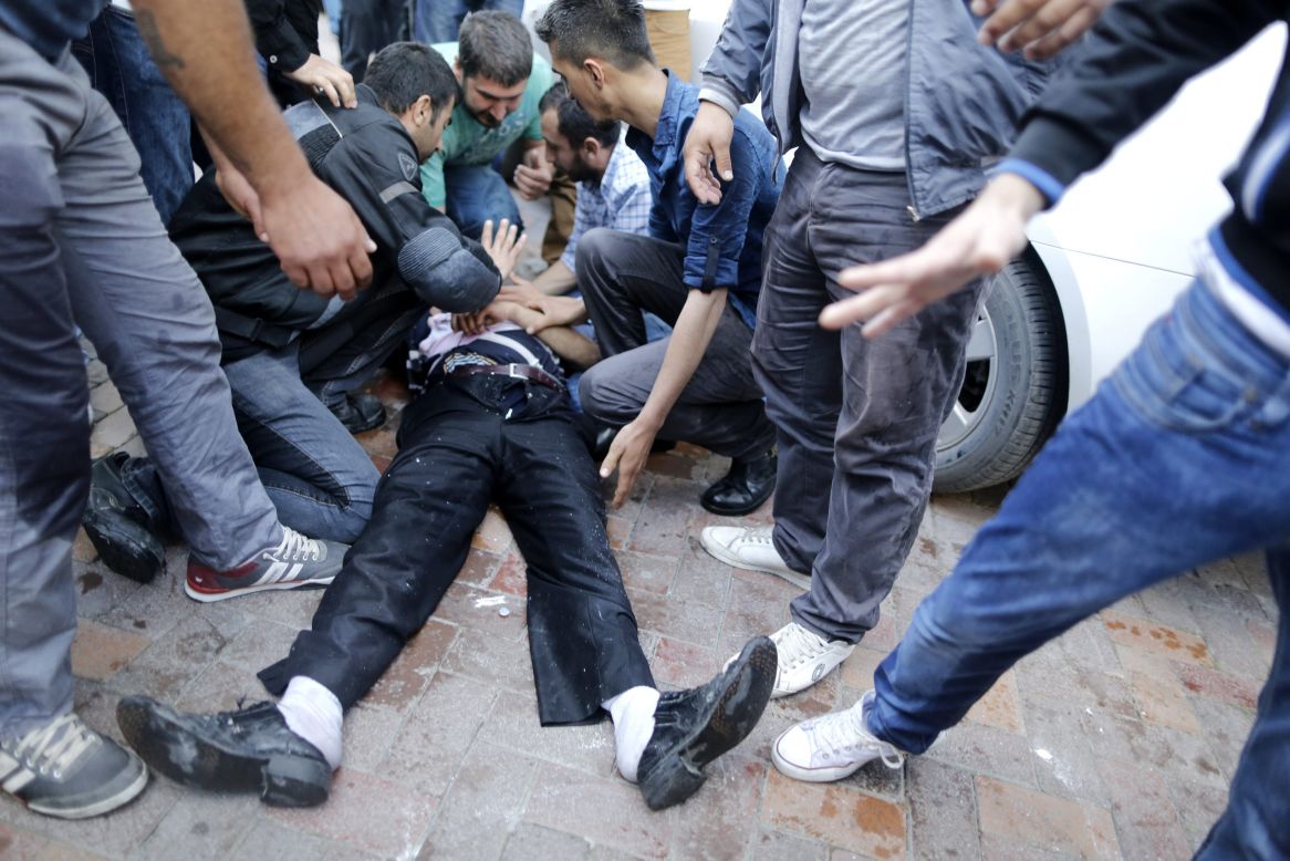 People try to help an injured man who was hit by the jet of a police water cannon on Friday, May 16, during a protest against the government after a mine explosion in Soma, Turkey.  Hundreds have taken to the streets across the country since nearly 300 miners died in a mine fire near Soma on May 13, protesting the government and a lack of safety regulations. Unions called for strikes May 15.