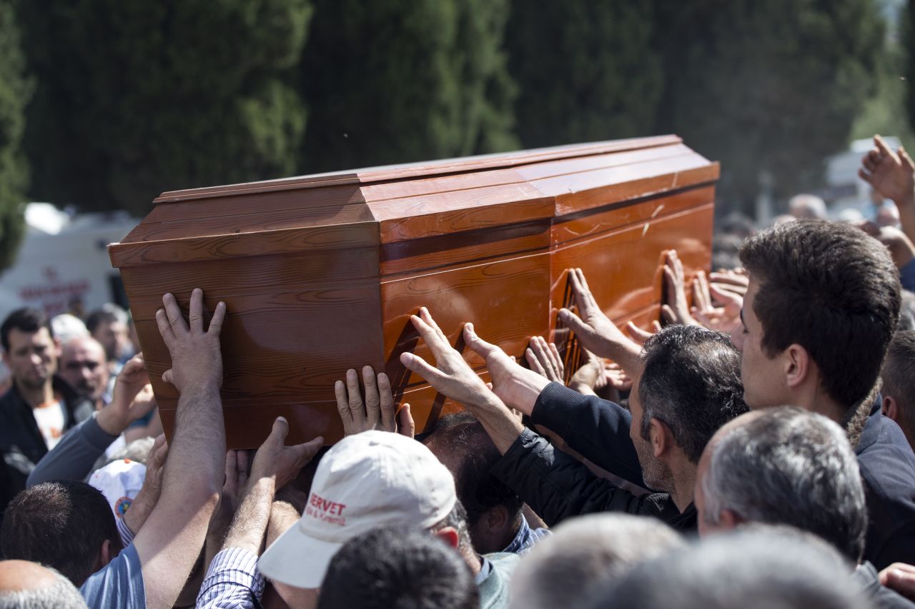 Mourners reach out to touch the coffin of a miner recovered from the Soma mine on May 17.