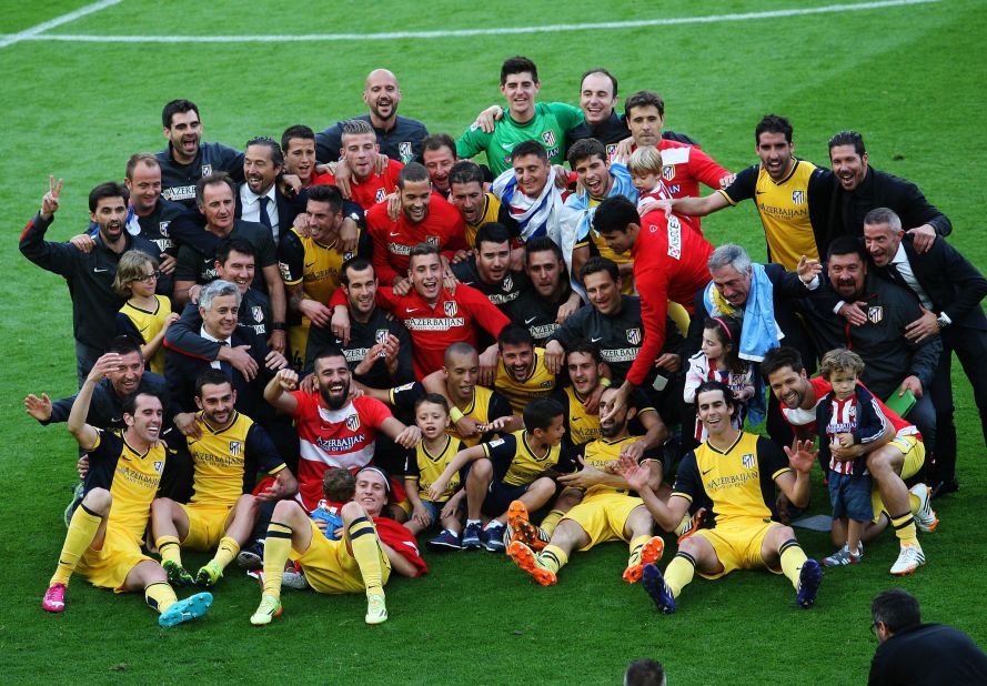 Atletico's players, staff  and family members pose for the cameras following a dramatic denouement to the La Liga season.  