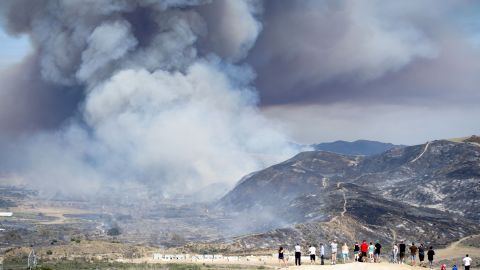 Residents watch a wildfire near San Diego on Friday, May 16. Wildfires devoured more than 20,000 acres in San Diego County after a high-pressure system brought unseasonable heat and gusty winds to the parched state.