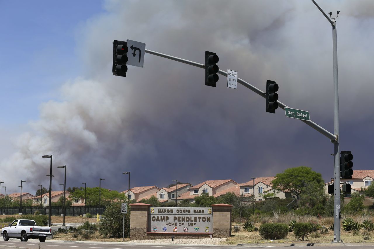 Smoke plumes rise May 16 behind the entrance to Camp Pendleton, a U.S. Marine Corps base.