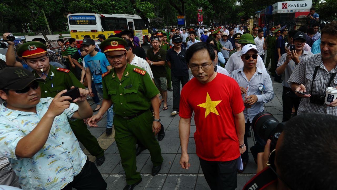 Policemen ask people to leave a street near to the Chinese embassy in Hanoi on May 18, 2014. A call for further anti-China protests appeared to have fizzled in the capital, with authorities deploying heavy security around the Chinese embassy and other suspected protest sites. AFP PHOTO/HOANG DINH Nam (Photo credit should read HOANG DINH NAM/AFP/Getty Images)