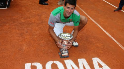 Novak Djokovic displays his Rome Masters trophy after coming back to beat Rafael Nadal.