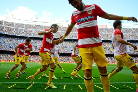 Ateltico Madrid warmed up in front of a partisan home crowd. While more than 90,000 Catalans were in the Nou Camp, less than 500 tickets were given to Atletico fans.