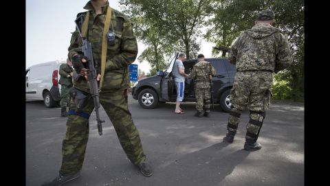 Pro-Russian armed militants guard a checkpoint in Slovyansk on May 19, blocking a major highway to Kharkiv.