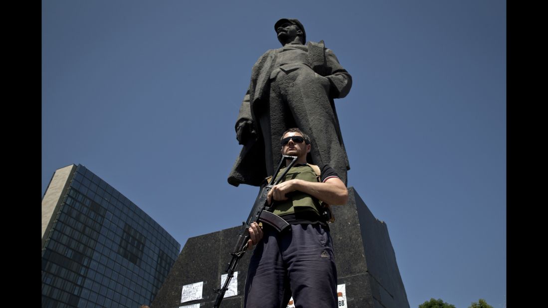 A bodyguard of insurgent leader Denis Pushilin stands in front of a statue of Russian revolutionary Vladimir Lenin during a pro-Russia rally in Donetsk on May 18.