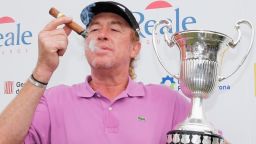 Miguel Angel Jimenez of Spain smokes his cigar and poses with the trophy after winning the Open de Espana held at PGA Catalunya Resort on May 18, 2014 in Girona, Spain. (Photo by Dean Mouhtaropoulos/Getty Images