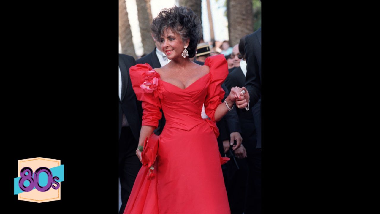 Where in 1957 she wore white, now Elizabeth Taylor attends the 40th Cannes Film Festival in red. The Nolan Miller dress which features iconic shoulder pads has become one of her best known outfits, along with her many wedding dresses. 