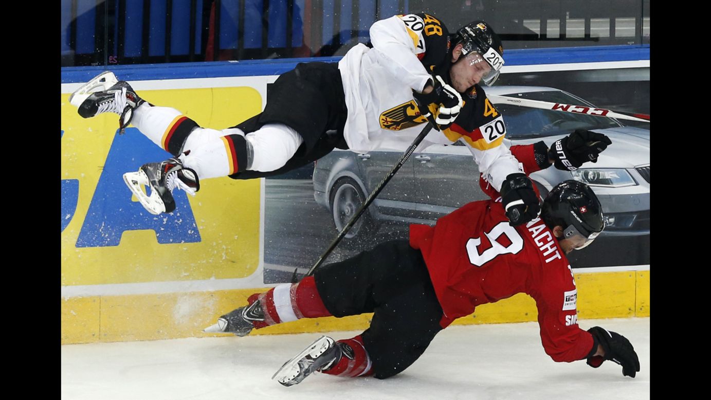 Switzerland's Thomas Rufenacht, bottom, collides with Germany's Frank Hordler during a game Wednesday, May 14, at the Ice Hockey World Championship in Minsk, Belarus. Switzerland won the game 3-2, but neither team was able to advance out of the group stage of the tournament, which ends later this month.