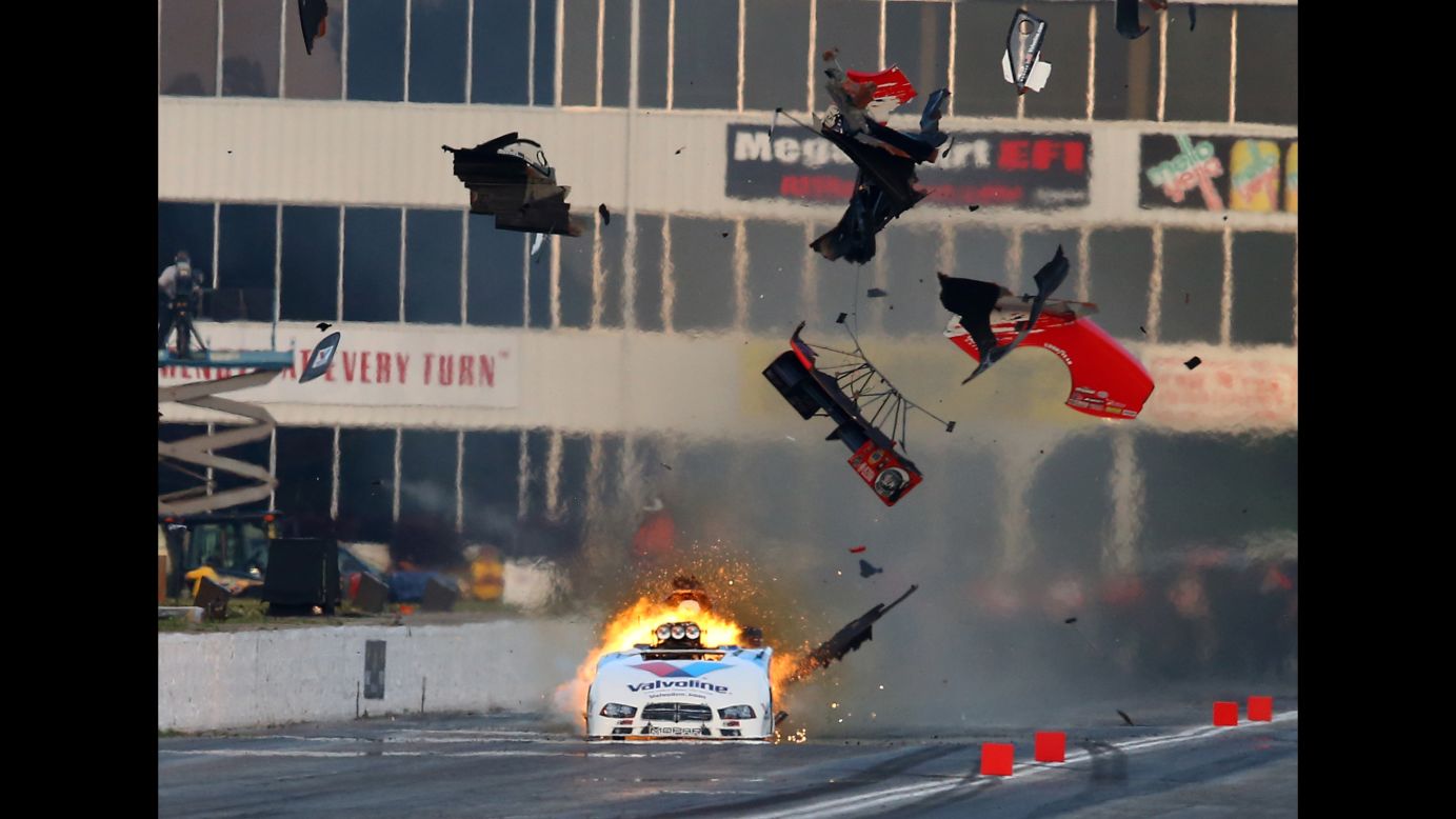 An engine explodes on the funny car of NHRA driver Jack Beckman, sending pieces of the car's carbon-fiber body into the air Saturday, May 17, during qualifying for the Southern Nationals at Atlanta Dragway. Beckman was unhurt in the explosion.