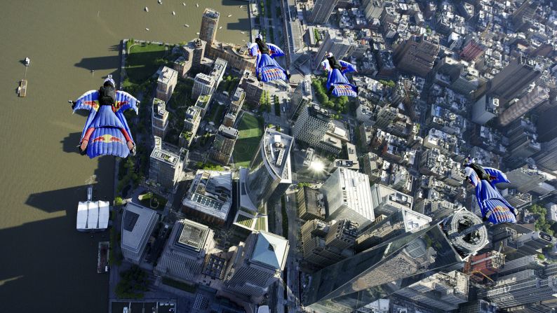 Members of the Red Bull Air Force -- Jon Devore, Jeff Provenzano, Amy Chmelecki and Sean MacCormac -- soar past One World Trade Center during a wingsuit flight in New York City on Sunday, May 18. It was the first time a wingsuit flight was permitted to take place over New York.