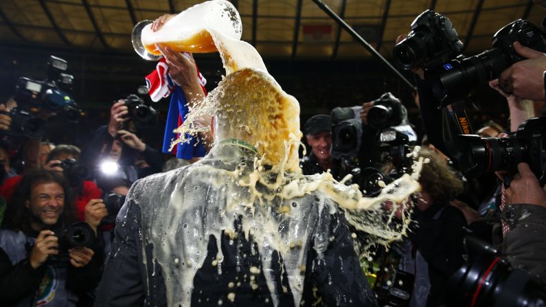 Bayern Munich manager Pep Guardiola is showered with beer after his team won the German Cup final Saturday, May 17, in Berlin. Bayern defeated Borussia Dortmund 2-0 to complete the domestic double this season. They also won the German league title.