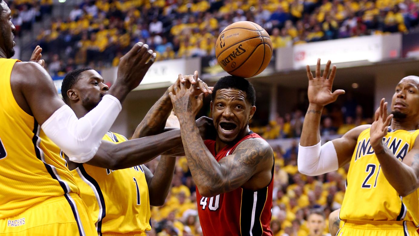 The Miami Heat's Udonis Haslem, center, loses control of the ball during Game 1 of the NBA's Eastern Conference finals Sunday, May 18, in Indianapolis. The Indiana Pacers won the series-opening game 107-96.