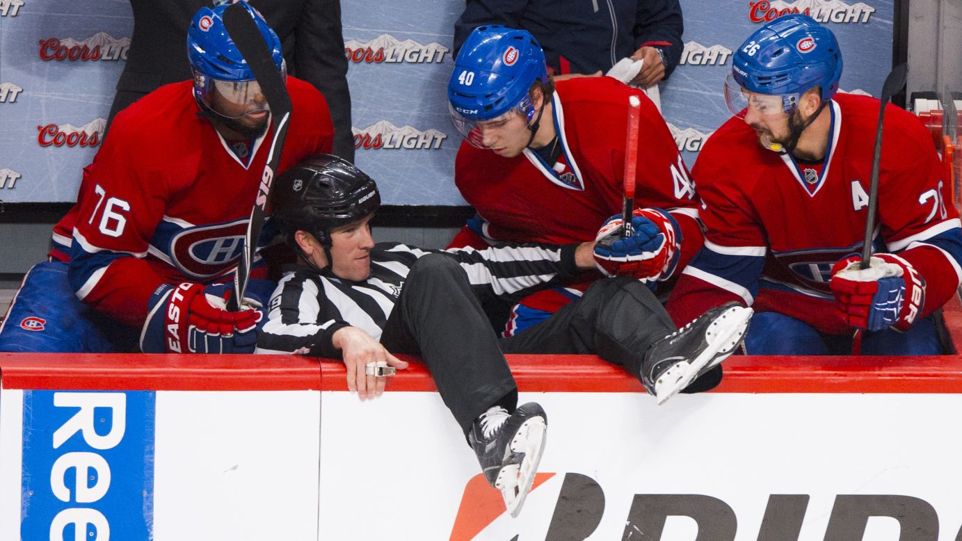 Linesman Steve Barton is helped up after he fell into the Montreal Canadiens' bench Saturday, May 17, in Game 1 of the NHL's Eastern Conference finals. Montreal lost 7-2 in the series-opening game against the New York Rangers.
