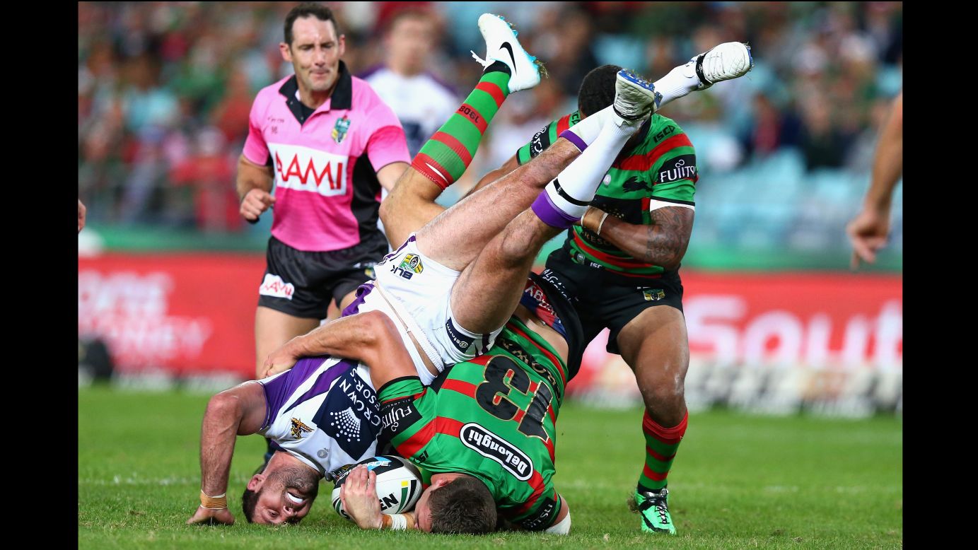 Bryan Norrie of the Melbourne Storm is tackled by Sam Burgess of the South Sydney Rabbitohs during a National Rugby League match Friday, May 16, in Sydney. The Storm won the match 27-14.