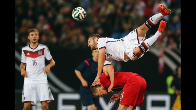 Shkodran Mustafi of Germany jumps over Arkadiusz Milik of Poland during an international match Tuesday, May 13, in Hamburg, Germany. The exhibition ended 0-0.