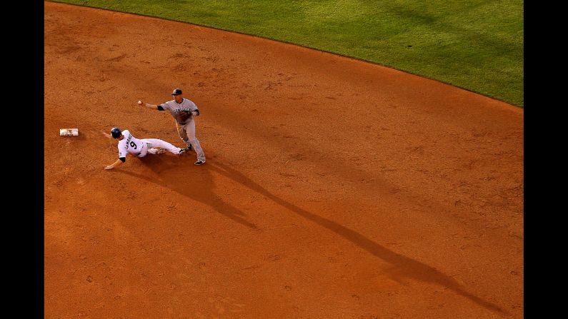 San Diego Padres shortstop Everth Cabrera avoids a sliding DJ LeMahieu to turn a double play in the Padres' 8-5 win over the Colorado Rockies on Saturday, May 17, in Denver.