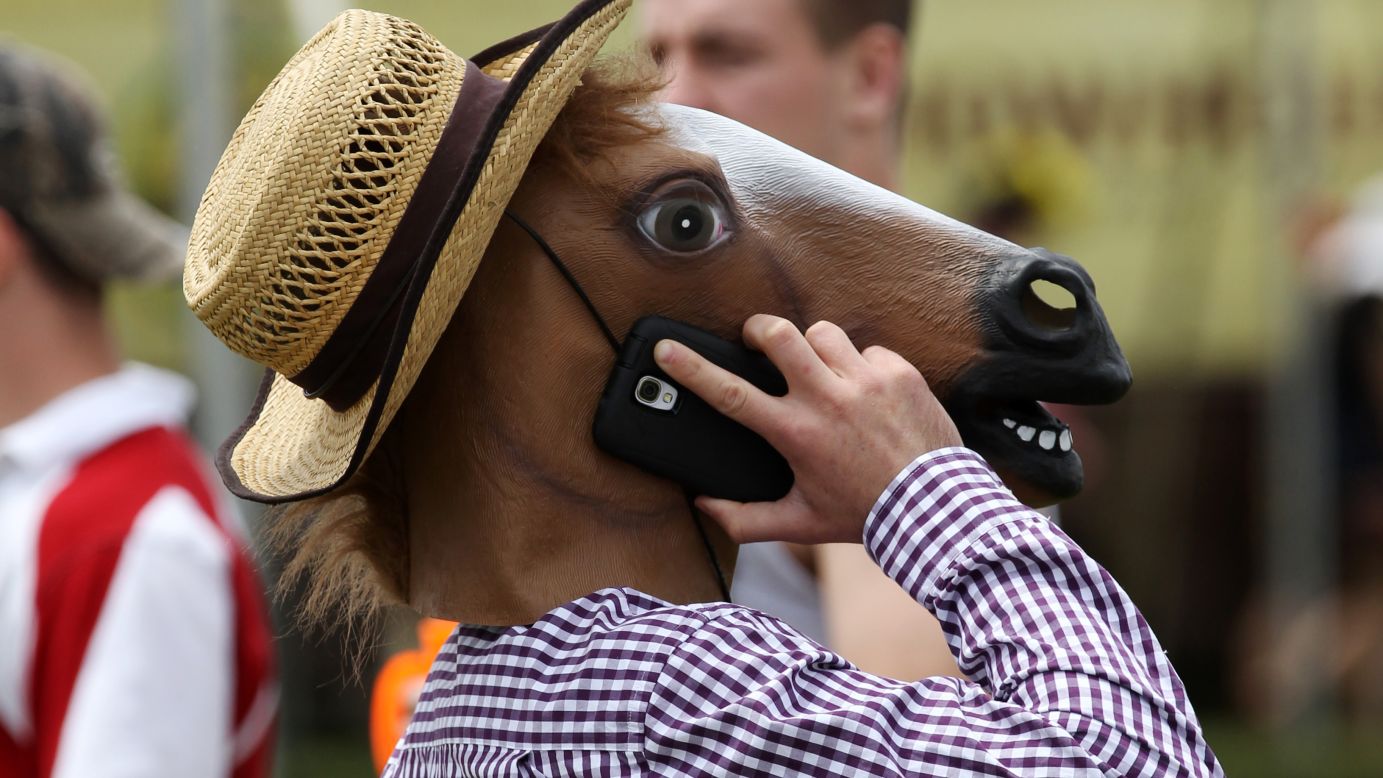 A fan in a horse mask talks on his cell phone before the Preakness Stakes in Baltimore on Saturday, May 17.