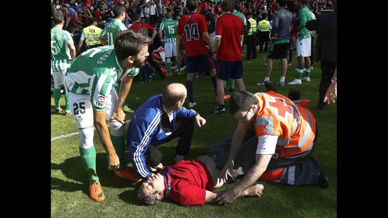 An injured fan receives medical assistance after a railing collapsed Sunday, May 18, during a Spanish league soccer match between Osasuna and Real Betis in Pamplona, Spain. Several fans were injured in the collapse, which happened after Osasuna's opening goal in the 12th minute of play. The match resumed after 35 minutes, and Osasuna won 2-1.