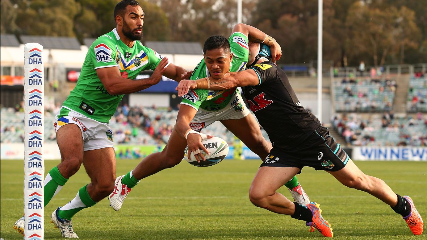 Jamie Soward of the Penrith Panthers attempts to tackle Anthony Milford of the Canberra Raiders before Milford scores a try during the National Rugby League match Sunday, May 18, in Canberra, Australia. Penrith won 26-20.