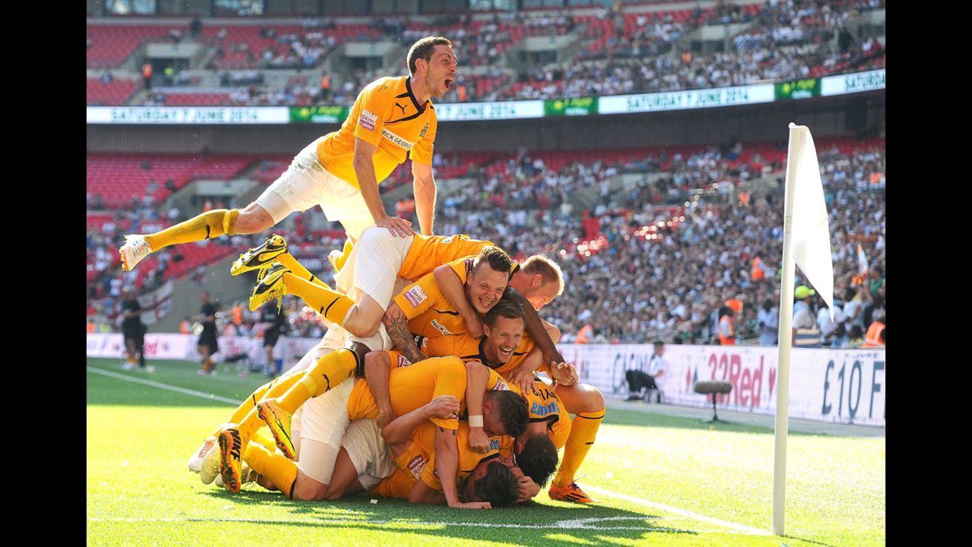 Cambridge United players celebrate a goal by Ryan Donaldson during the Conference Premier playoff final Sunday, May 18, in London. The team's 2-1 win over Gateshead secured its promotion into England's Football League.