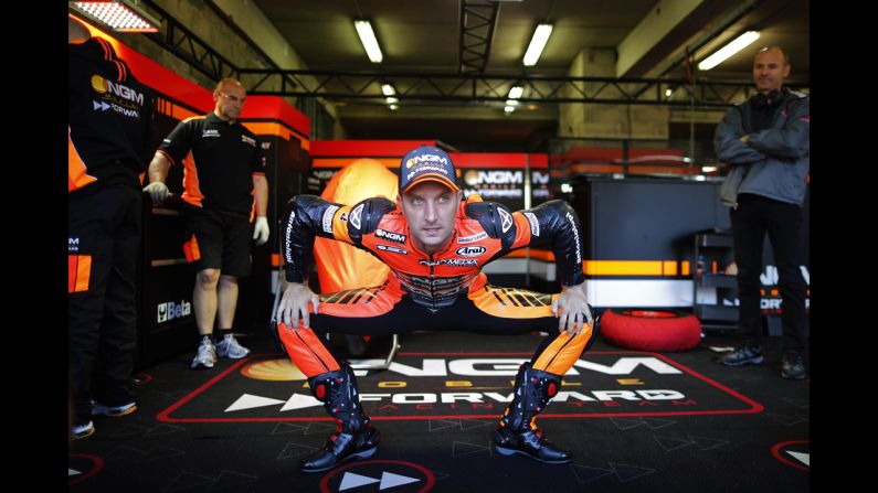 MotoGP rider Colin Edwards is seen in his garage before a practice session Saturday, May 17, at the French Grand Prix in Le Mans, France. The race was won by Marc Marquez, who has won all five MotoGP events this season. <a href="index.php?page=&url=http%3A%2F%2Fwww.cnn.com%2F2014%2F05%2F13%2Fworldsport%2Fgallery%2Fwhat-a-shot-0513%2Findex.html">See 41 amazing sports photos from last week</a>