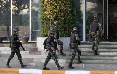 Thai soldiers walk into the National Broadcasting Services of Thailand building on May 20. All Thai TV stations were being guarded by the military.