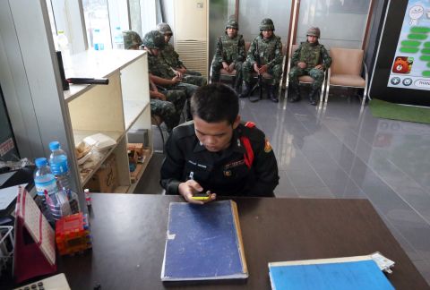 Soldiers sit in the lobby of the National Broadcasting Services of Thailand building on May 20.
