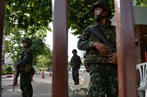 Thai soldiers stand guard outside the Government Public Relations Department in Bangkok on May 20.