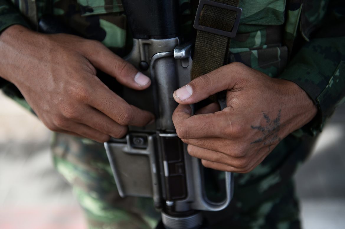 A soldier grips his gun outside the Government Public Relations Department building on May 20.