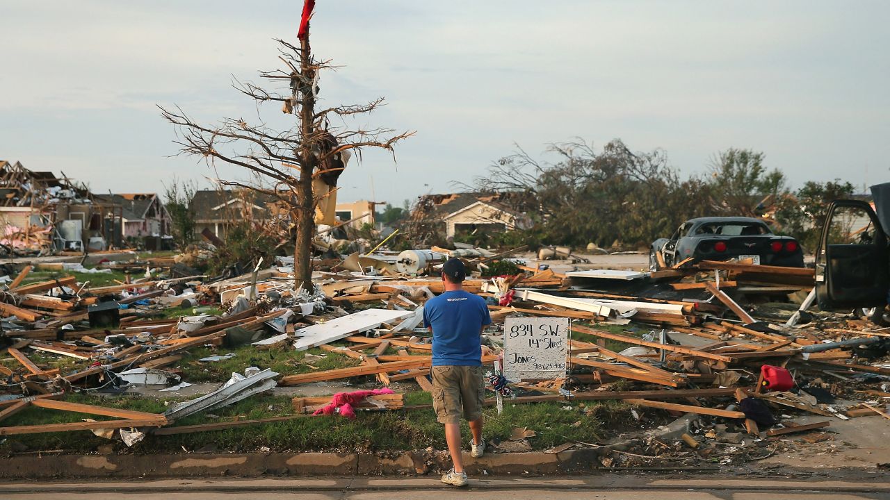 <strong>Then:</strong> Matt Bedoe stands in front of the home of his friend and co-worker Rick Jones on May 25, 2013. Jones, a 54-year-old postal worker, died when his house collapsed during the tornado.