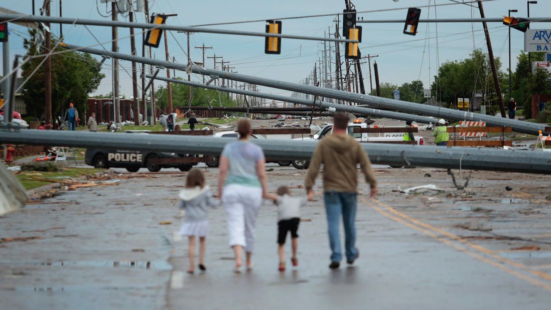 <strong>Then: </strong>Downed utility poles block the road on May 21, 2013.