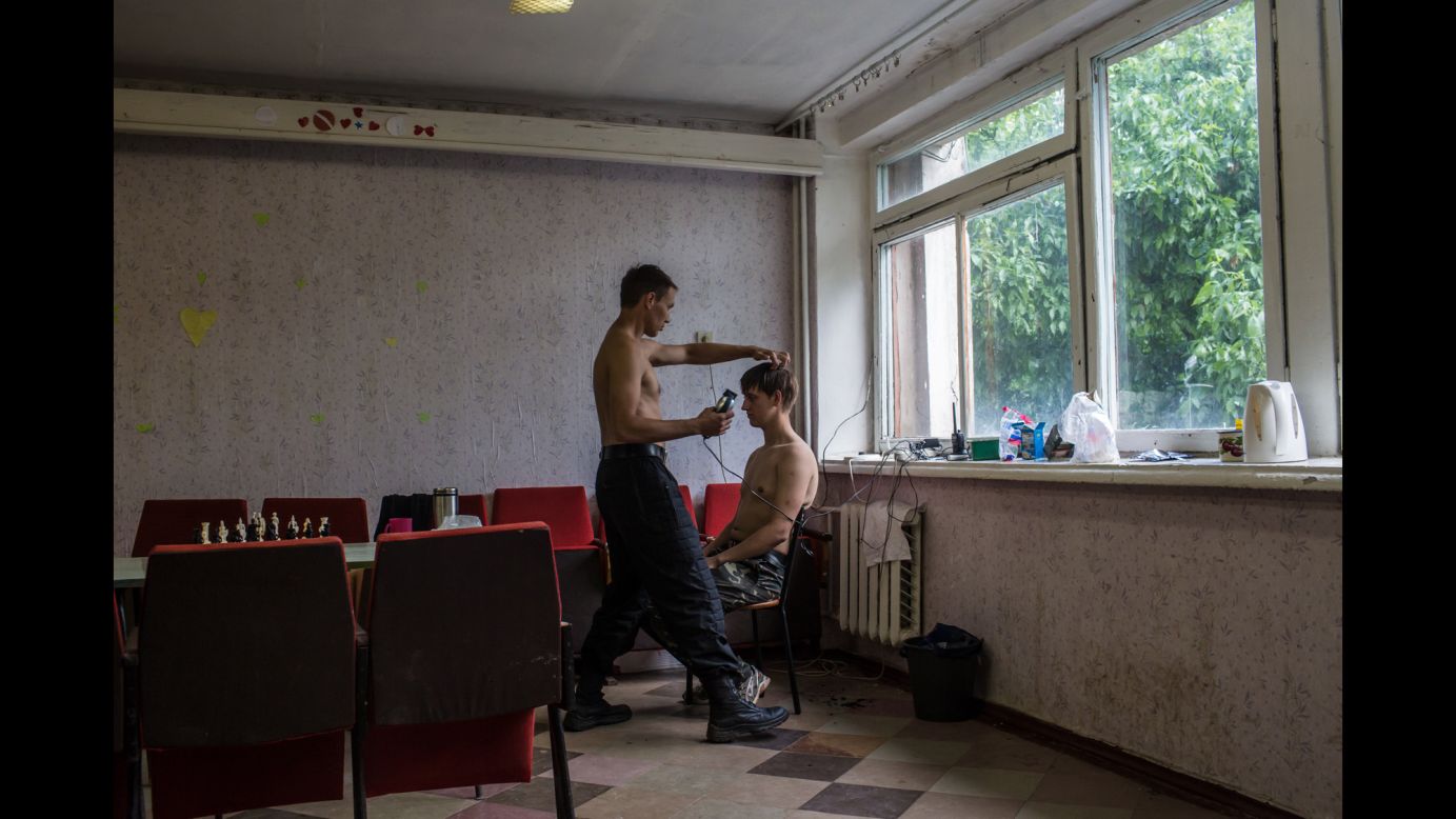 A new recruit gets his hair cut at a training camp for the Donbass Battalion, a pro-Ukrainian militia, in the Dnipropetrovsk region of Ukraine on May 19.