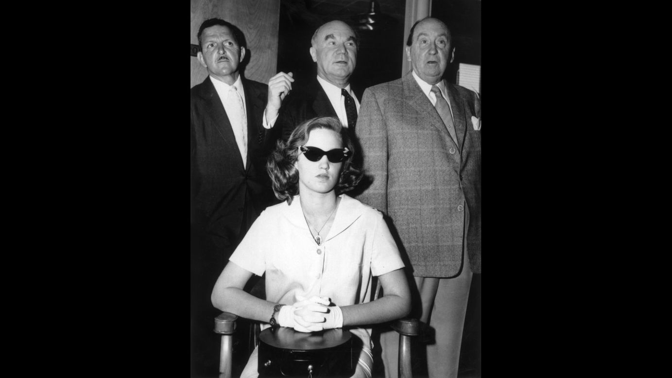 In 1958, a then-14-year-old Cheryl Crane, daughter of actress Lana Turner, stabbed her mother's boyfriend, Johnny Stompanato. Crane told police that Stompanato, who had ties to organized crime, had threatened her mother with a knife. Here, Crane is shown with three unidentified men at the time of her trial, which resulted in a ruling of justifiable homicide. 