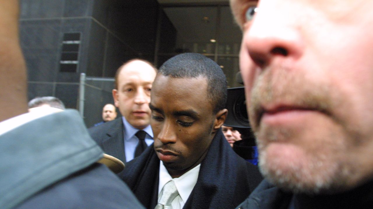Sean Combs, then known as "Puffy," is flanked by security and court guards as he leaves the first day of his trial in January 2001 in New York. The rapper/producer was charged in connection with a 1999 shooting in a New York nightclub. He was found not guilty of all charges. 