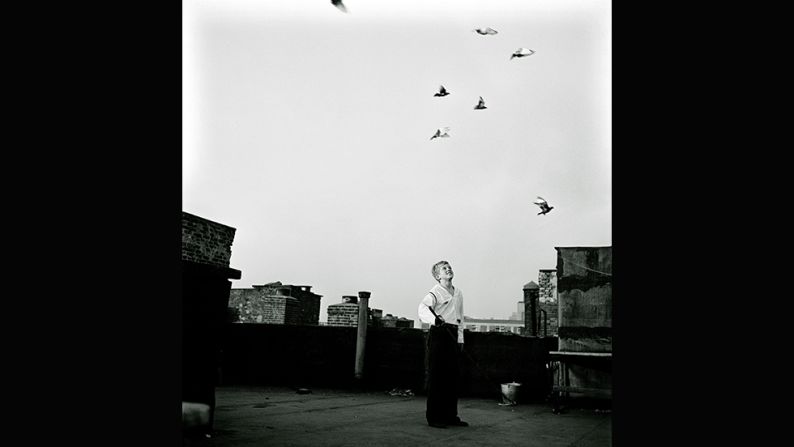 <em>Shoe Shine Boy -- Mickey with pigeons, 1947</em><br /><br />Kubrick captured more than Mickey's working life. He still goes to school and to the movies, and enjoys other childhood pursuits. <br /><br />"Here you can see him on the roof of a Brooklyn house where he is keeping pigeons," Ortner-Kreil says. "Observing the pigeons flying freely is a metaphor for freedom. He has changed his clothes so he is wearing a proper white shirt and is no longer a shoe shine boy. It's a different story." 