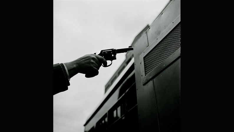 <em>Paddy Wagon -- Gun, 1948</em><br /><br />Kubrick was familiar with photos of police work and criminality, which were popularized by the photographer <a href="index.php?page=&url=http%3A%2F%2Fen.wikipedia.org%2Fwiki%2FWeegee" target="_blank" target="_blank">Weegee</a>. <br /><br />"But while Weegee's images are characterized by their hard realism and a somewhat voyeuristic brutality, Kubrick offers <em>Look</em>'s readership a violence-free, object-interested and precisely arranged image of criminality. He works with cinematic features like the cut or the close-up."<br /><br />This image shows a gun pointed at a Paddy Wagon, a vehicle that transported 700 prisoners a day in New York City.   