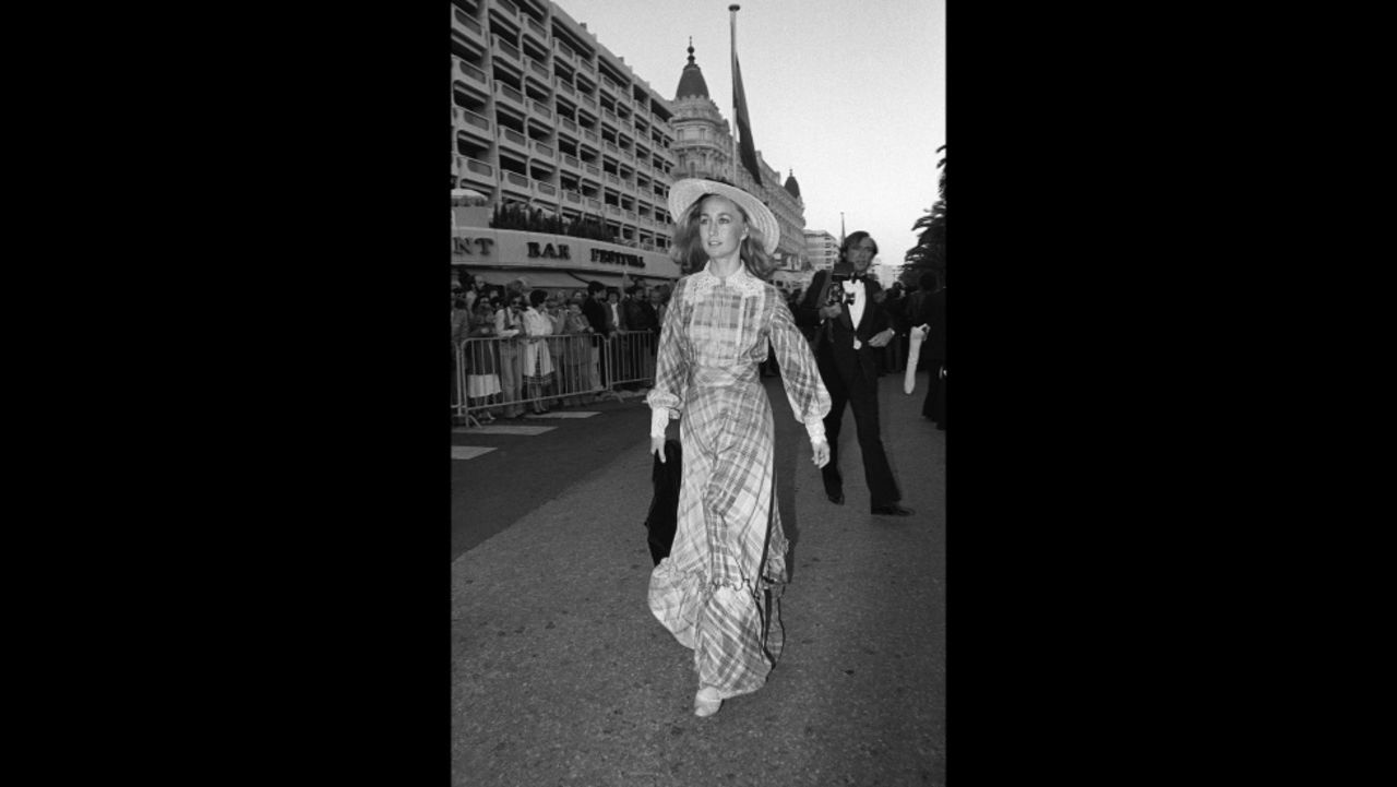 French actress Brigitte Fossey arrives at the 1977 film festival in long checked dress with lace detailing and a provincial straw hat. Fossey was just five years old when she was cast by director René Clément to star in his film, "Forbidden Games." 