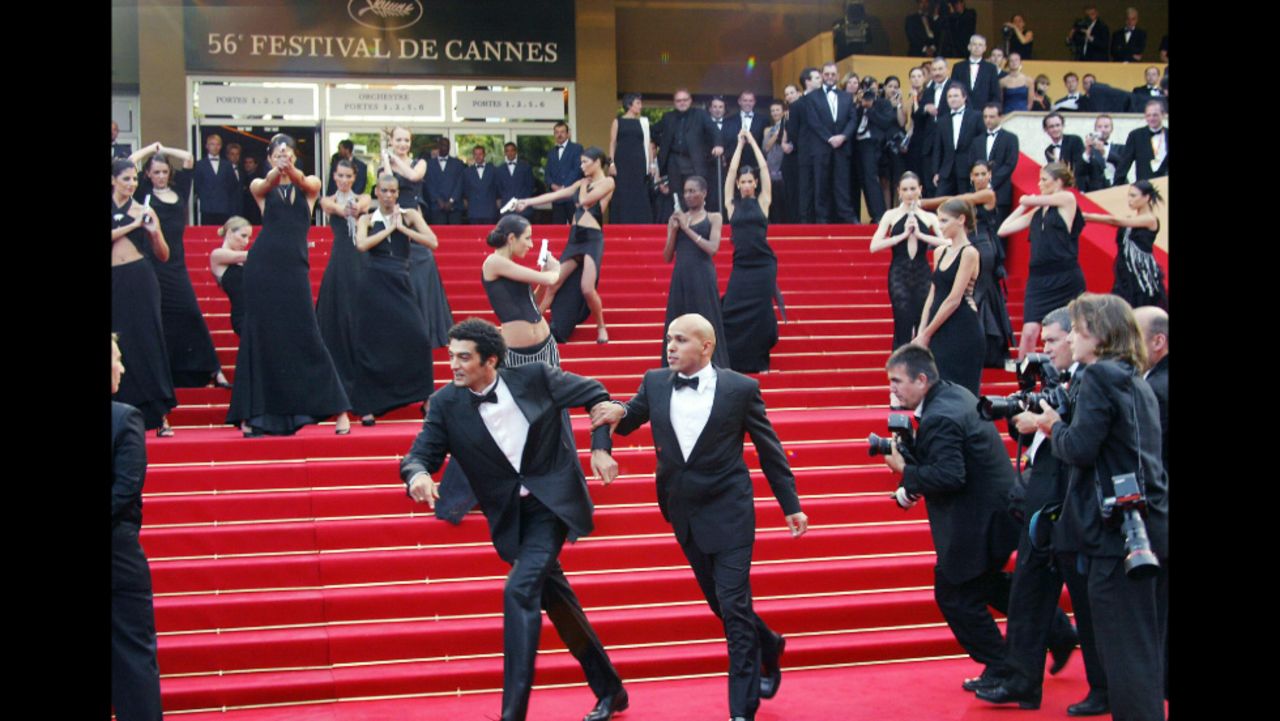 Being chased by paparazzi and shot at by Bond girls is just another day in the life of french humorist duo Erik et Ramzy. The pair joke with the Bond girls upon arrival at the Palais des festivals before the screening of the film "La Petite Lili" by French director Claude Miller during the Cannes film festival in 2003. 