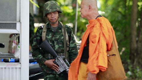 A Buddhist monk walks past a Thai soldier near a pro-government demonstration on the outskirts of Bangkok on Wednesday, May 21.