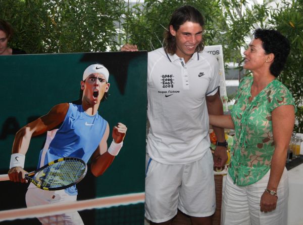 Nadal receives a painting from artist Frederique Lorin as a birthday present. It shows Nadal celebrating after defeating Nicolas Almagro at the French Open in 2008.
